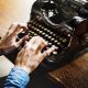 hands typing on a vintage typewriter