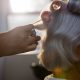 Photo of a woman getting her hair curled at a beauty parlour