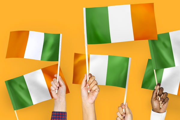 Illustration of a number people waving an Irish flag
